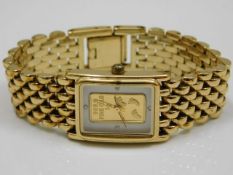 A gold plated watch with "Footprints" poem to vers