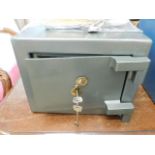 A small key operated safe 13.125in wide x 10.25in