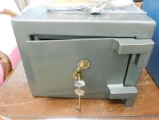 A small key operated safe 13.125in wide x 10.25in