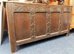 An 18thC. oak coffer with carved decor 53in wide x