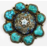 A decorative brooch set with turquoise on silver &