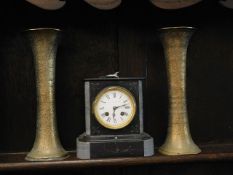 A small French slate clock twinned with to chased