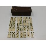 A 19thC. set of bone dominoes with box