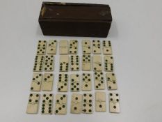 A 19thC. set of bone dominoes with box