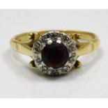 An 18ct gold ring set with diamonds & red stone a/