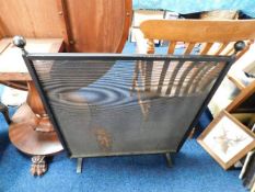 A steel mesh fire screen 36in high x 32.5in wide