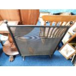 A steel mesh fire screen 36in high x 32.5in wide