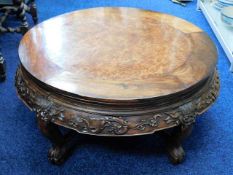 An early 20thC. finely carved low level Oriental opium table, with burr wood top 30.5in wide x 14in