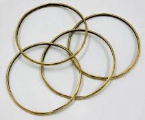 A set of four yellow metal bangles a/f test as 18c