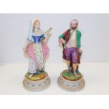 A pair of 19thC. continental bisque figures 13in tall, loss to ladies small finger