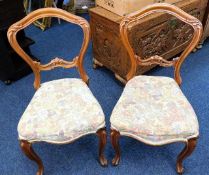 A pair of 19thC. carved walnut balloon back chairs