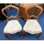 A pair of 19thC. carved walnut balloon back chairs