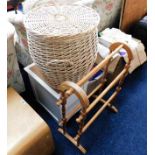 A pine towel rail twinned with a wicker laundry ba