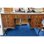 A decorative antique nine drawer desk with brass h