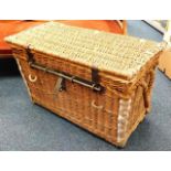 An antique wicker steamer/car trunk with strap loo