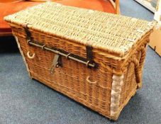 An antique wicker steamer/car trunk with strap loo