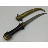 A Persian style dagger with decorative brass sheaf