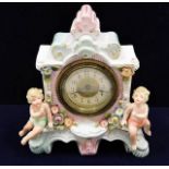 A Sitzendorf porcelain clock with cherub decor
