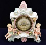 A Sitzendorf porcelain clock with cherub decor