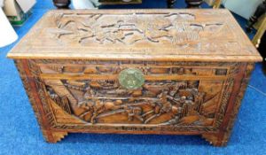 A 20thC. carved camphor wood chest with Chinoserie