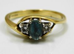 An 18ct gold ring set with diamond & possibly aqua