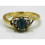 An 18ct gold ring set with diamond & possibly aqua