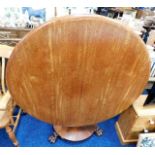 A Victorian tilt top breakfast table with claw fee