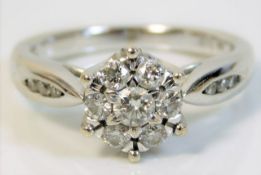 An 18ct white gold daisy style ring set with 0.5ct