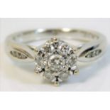 An 18ct white gold daisy style ring set with 0.5ct