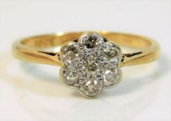 An 18ct gold daisy ring with platinum mounted diam