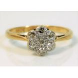 An 18ct gold daisy ring with platinum mounted diam