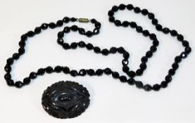 A jet beaded necklace, 32in long twinned with a ca