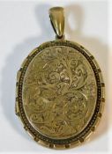 A yellow metal locket, tests at least 9ct gold 12.