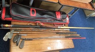 A collection of various golf clubs including hicko