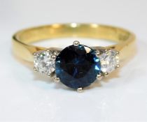 An 18ct gold ring set with 0.3ct diamond & sapphir