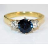 An 18ct gold ring set with 0.3ct diamond & sapphir