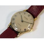 A gents 9ct gold watch with leather strap, British
