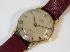 A gents 9ct gold watch with leather strap, British