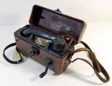 A cased field telephone