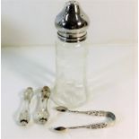 A decorative silver topped glass sifter twinned wi