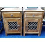 A pair of ethnic pine bedside cupboards 25in high