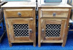 A pair of ethnic pine bedside cupboards 25in high