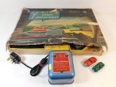 A boxed Minic motorway game with two cars, four co