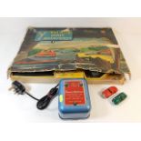 A boxed Minic motorway game with two cars, four co