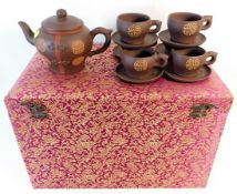 A cased Chinese tea set with six cups & saucers &