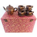 A cased Chinese tea set with six cups & saucers &