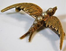 A Victorian 15ct gold swallow brooch with seed pea