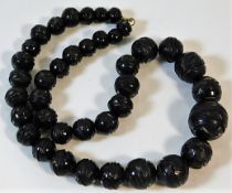 A c.1900 set of carved jet beads, some split 53.5g