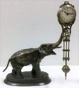 A German Junghans mystery swinger clock, 7.75in tall to top of elephant trunk