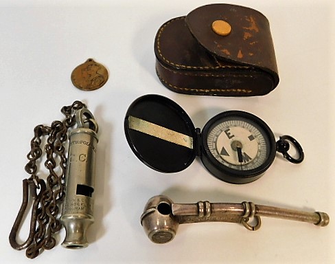 A small compass with case, a bosuns whistle, an L.C.C. (London County Council) "The Metropolitan" Ge